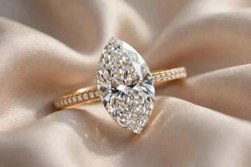 Marquise cut diamond engagement ring macro on champagne silk